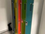brightly colored lockers are lined up against a wall in a room