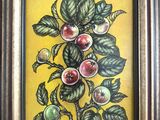 un tableau représentant un arbre chargé de fruits, dans un cadre