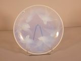 a white plate with fish on it on a stand