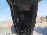 a close up of a car ' s rear view mirror on the side of the road