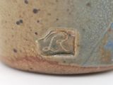 a close up of a brown and blue bowl with a kangaroo on it