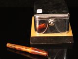 a pair of glasses and a pen sitting on a table