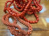 a table with a bunch of red beads on it