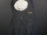 a black jacket with a hood on a mannequin stand