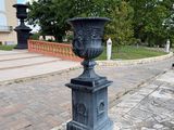 a black urn sitting on the side of the road