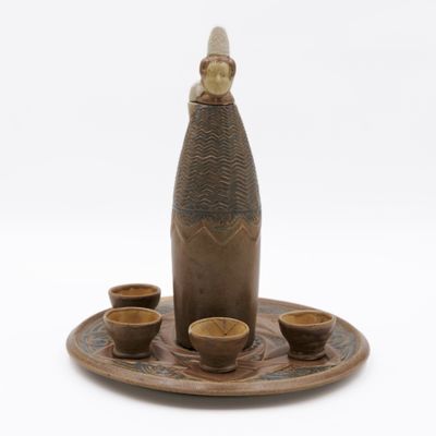 a picture of a bottle and cups on a tray