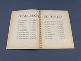 an open book with french words on it on a table