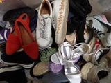 many pairs of shoes that are sitting on the floor