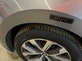 a close up of a car ' s tire with a sticker on it