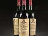 three bottles of wine sitting on top of a table next to each other