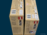 two boxes of food sitting on top of each other