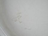 a close up of a white bowl with water in it