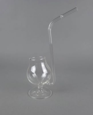 un gros plan d'un verre avec une paille à côté