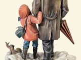a figurine of a man and a child with umbrellas
