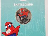 skateboarder pin featuring a red bird on a skateboard in front of a blue background