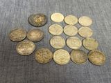 several different types of coins on a table with a blue cloth