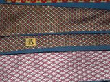 several ties are stacked on top of each other on a table