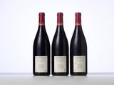 three bottles of wine sitting on top of a table next to each other