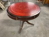 a round table with a red top in the middle of a room