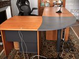 a desk with a chair and a lamp on it