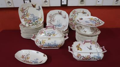 a lot of plates and bowls on the table
