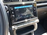 the dashboard of a car with a digital device in the center