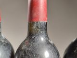 three bottles of wine sitting next to each other on a table