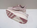 pink and white running shoes on a white surface