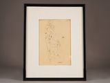 a drawing of a nude woman in a black frame on a table