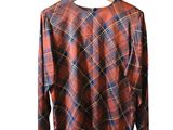 plaid shirt on hanger on wooden hanger against white background