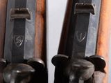 two wooden guns that are on display on a table