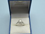 a diamond ring in a blue box on a table