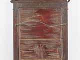 an old wooden cabinet with a door and a window on the side