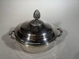 a large silver pot with a lid on a table