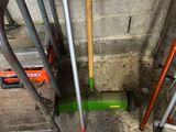 two shovels that are leaning against the wall
