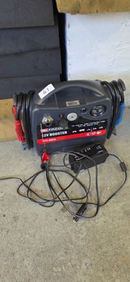 a black and red blower sitting on the floor next to a door