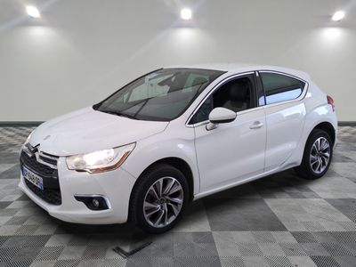 a white citrole parked on a checkered floor in a garage