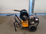a machine that is sitting on the ground in front of a building