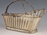 an antique wicker basket with a handle and a long handle