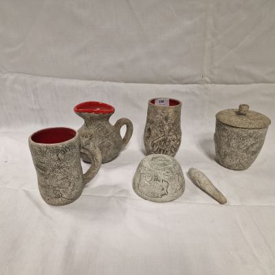four different types of pottery are displayed on a white surface