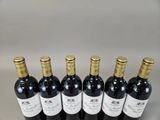 six bottles of wine are lined up in a row