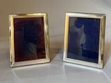 pair of silver picture frames with a picture of a man and a woman