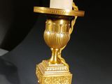 gold plated table lamp with a white glass shade and a gold plated base