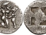 a silver coin with an image of a man and a woman on it