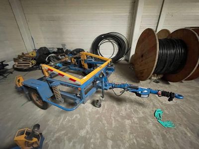 a blue cart with a bunch of wires on it