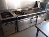 a kitchen with a stove, oven, and sink in it