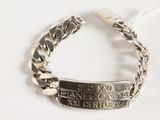 silver bracelet with engraved message on it on a white surface