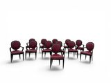 a group of red chairs sitting in a circle on a white surface
