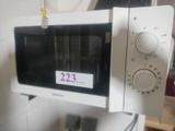 a white microwave oven sitting on top of a white counter