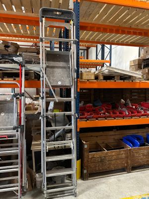 many shelves with various items on them in a warehouse